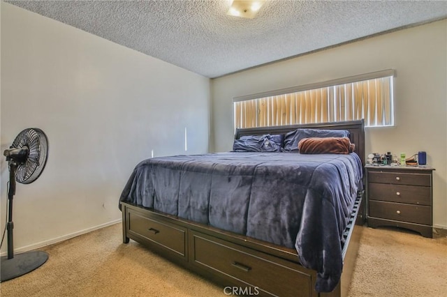 bedroom with light carpet and a textured ceiling