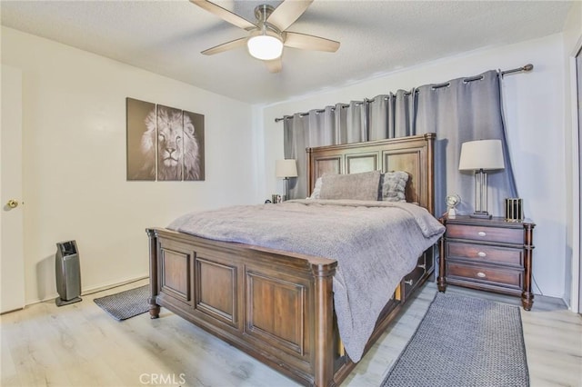 bedroom featuring ceiling fan and light hardwood / wood-style flooring