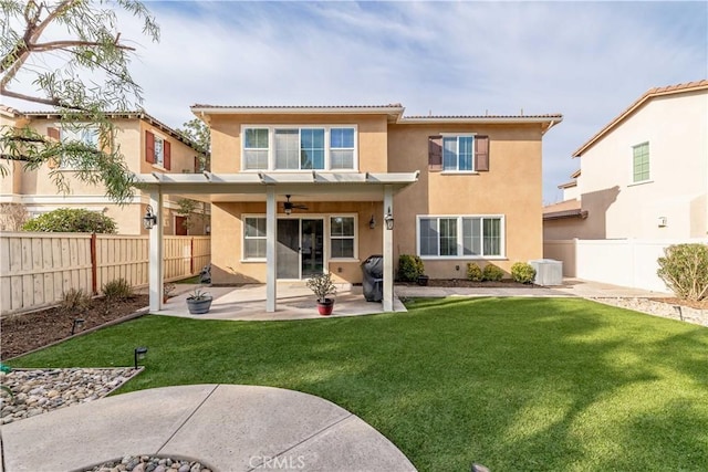 back of property featuring cooling unit, ceiling fan, a yard, and a patio area