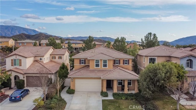 view of front of house featuring a garage and a mountain view