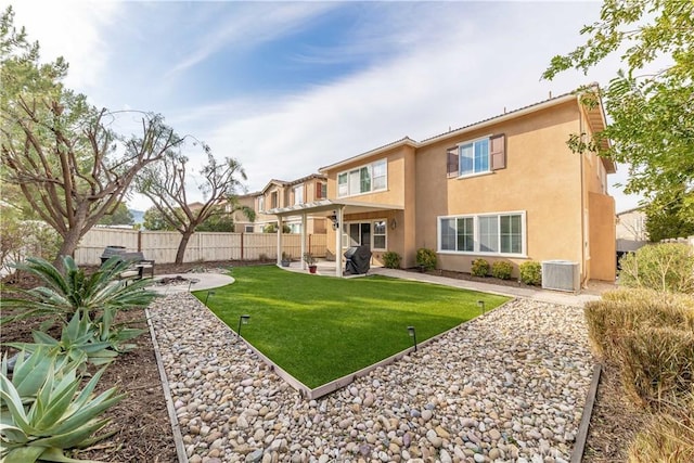 rear view of property featuring a patio, central AC, and a lawn