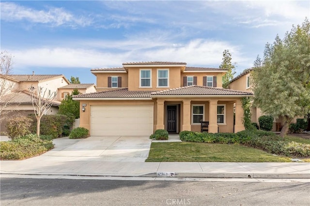 mediterranean / spanish house with a garage