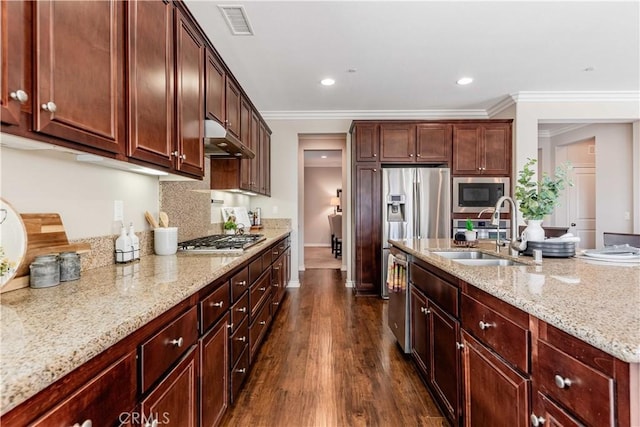 kitchen featuring sink, appliances with stainless steel finishes, dark hardwood / wood-style flooring, light stone countertops, and decorative backsplash