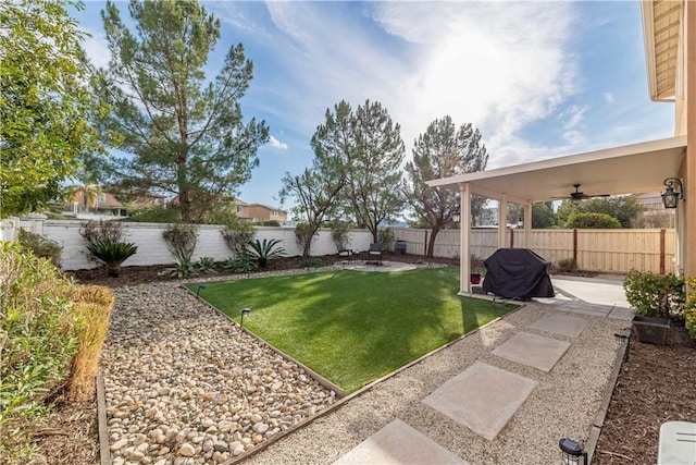 view of yard with a patio and ceiling fan