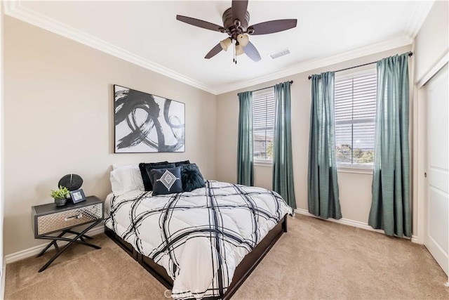 carpeted bedroom featuring ornamental molding and ceiling fan