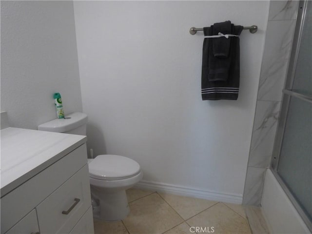 full bathroom with enclosed tub / shower combo, vanity, tile patterned floors, and toilet