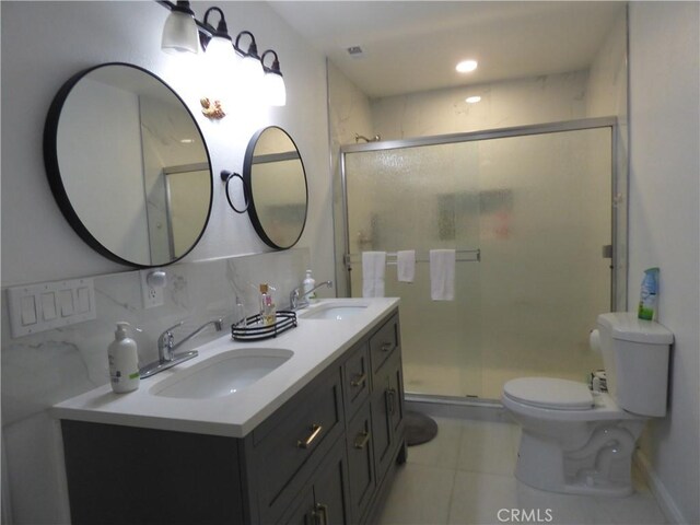 bathroom with a shower with door, backsplash, vanity, tile patterned floors, and toilet