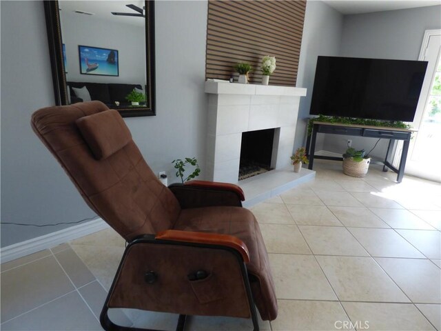 tiled living room featuring a fireplace