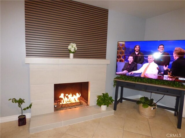 living room with light tile patterned floors and a fireplace