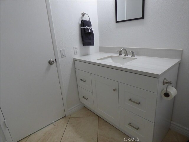 bathroom with tile patterned flooring and vanity