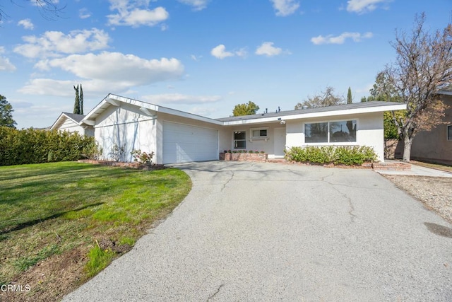 single story home with a garage and a front yard