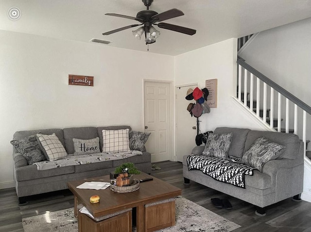 living room featuring dark hardwood / wood-style flooring and ceiling fan