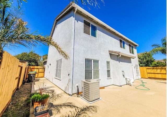 back of house featuring central AC unit and a patio area