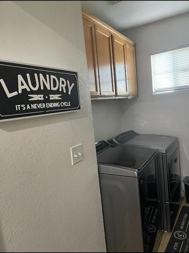 laundry area with cabinets and independent washer and dryer