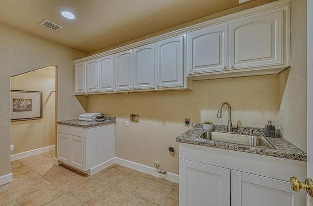 clothes washing area featuring gas dryer hookup, sink, hookup for a washing machine, cabinets, and hookup for an electric dryer