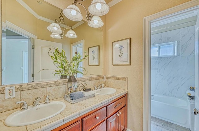 bathroom with a notable chandelier, ornamental molding, wood-type flooring, and vanity