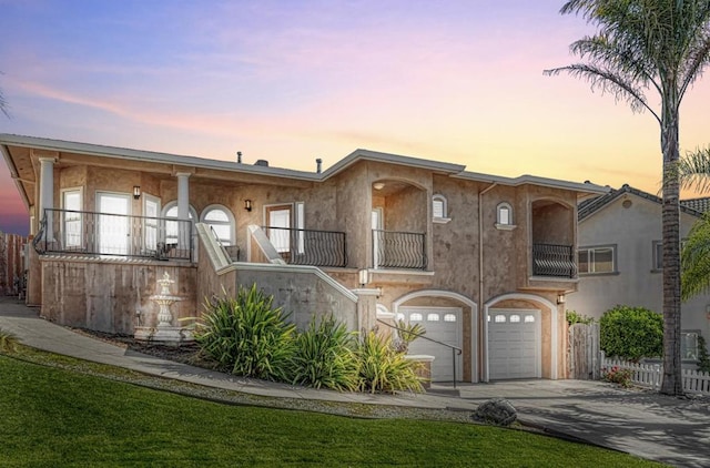 view of front of property featuring a garage and a balcony