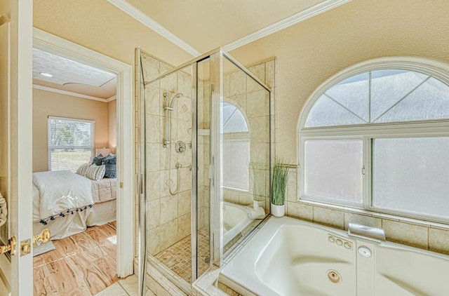 bathroom with ornamental molding and shower with separate bathtub