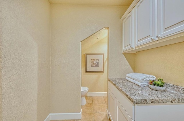 bathroom featuring tile patterned floors and toilet