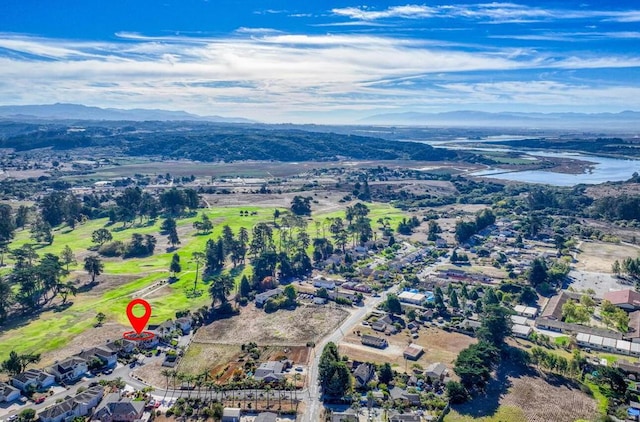 drone / aerial view featuring a water and mountain view