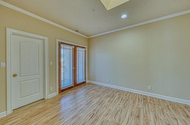 unfurnished room with french doors, crown molding, and light hardwood / wood-style flooring