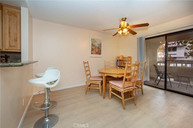 dining area featuring ceiling fan and light hardwood / wood-style floors