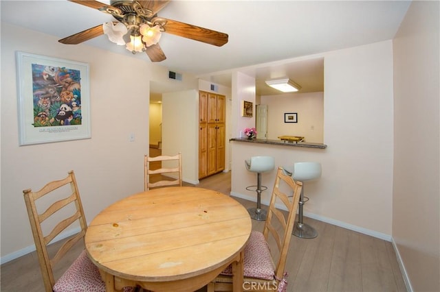 dining room featuring ceiling fan and light wood-type flooring