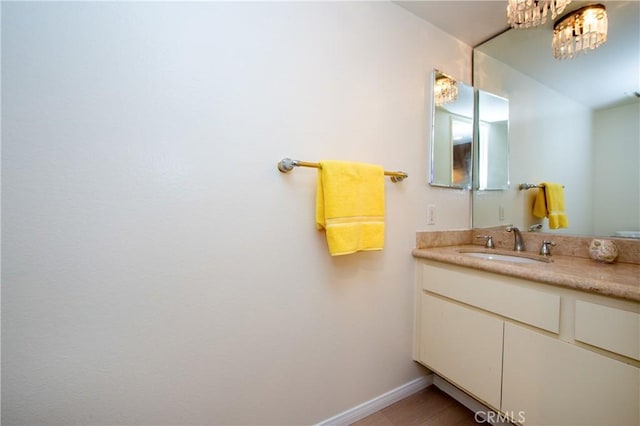 bathroom with vanity and a chandelier