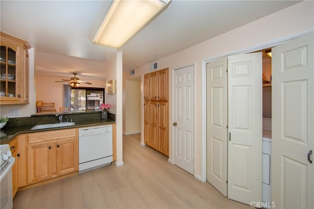 kitchen featuring sink, white appliances, dark stone countertops, light wood-type flooring, and ceiling fan