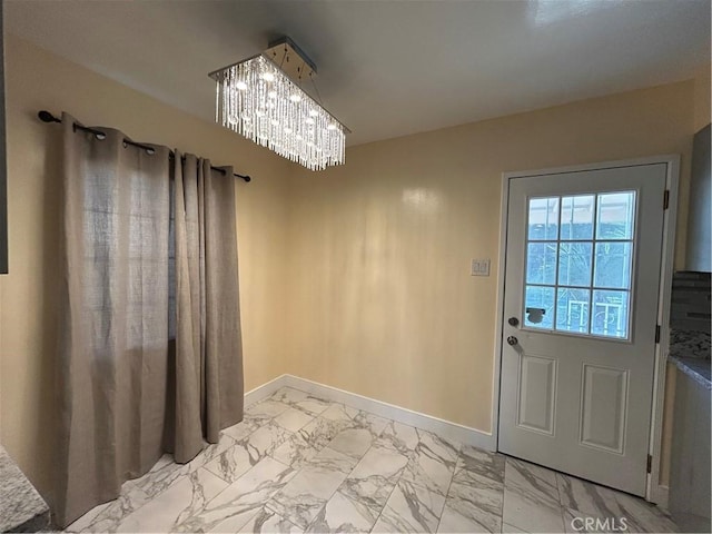 doorway to outside with a chandelier