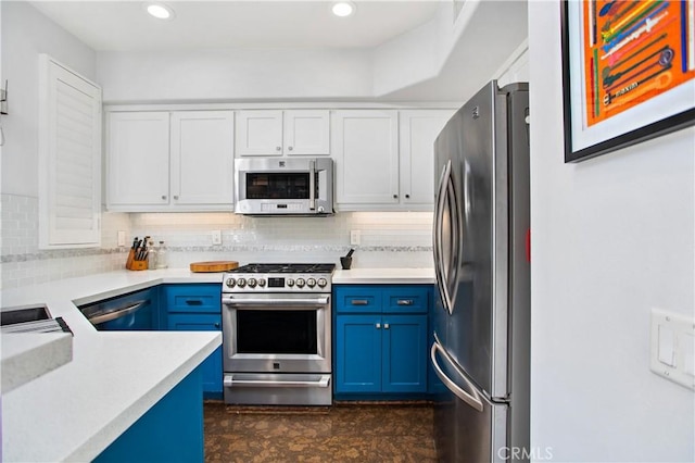 kitchen featuring tasteful backsplash, appliances with stainless steel finishes, blue cabinetry, and white cabinets