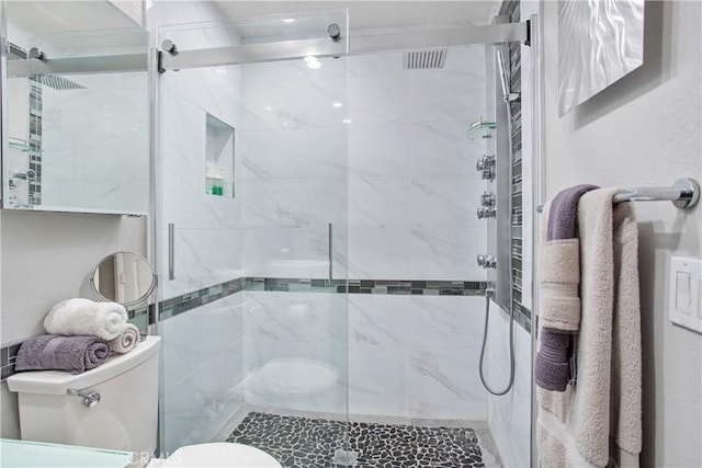 bathroom with toilet and walk in shower