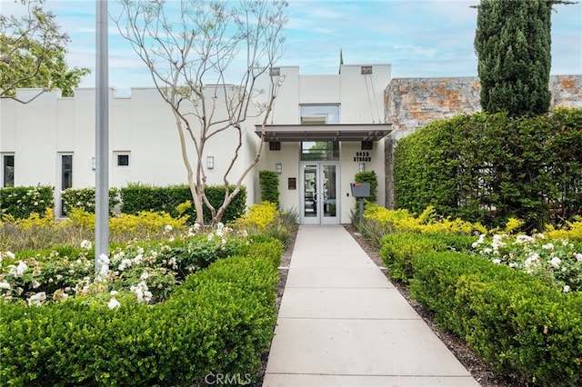 view of exterior entry featuring french doors