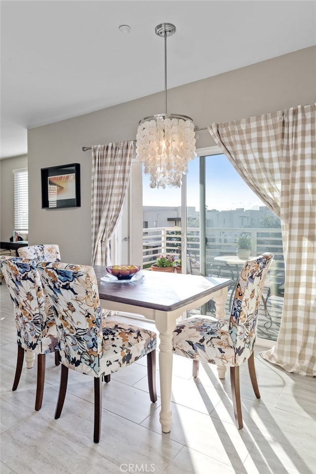 dining space featuring an inviting chandelier and plenty of natural light