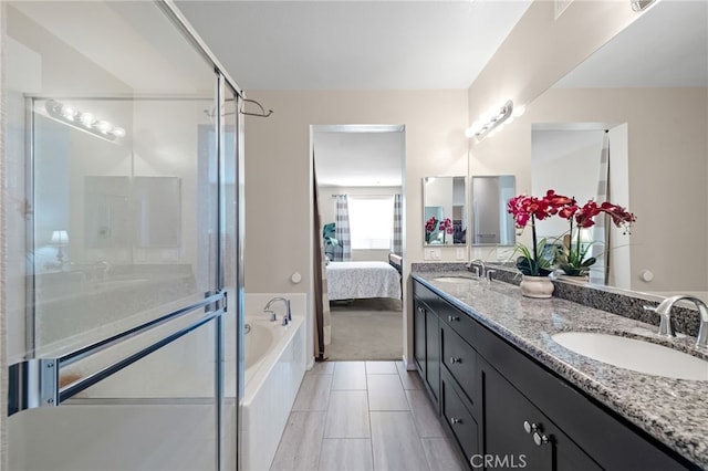 bathroom featuring vanity and independent shower and bath