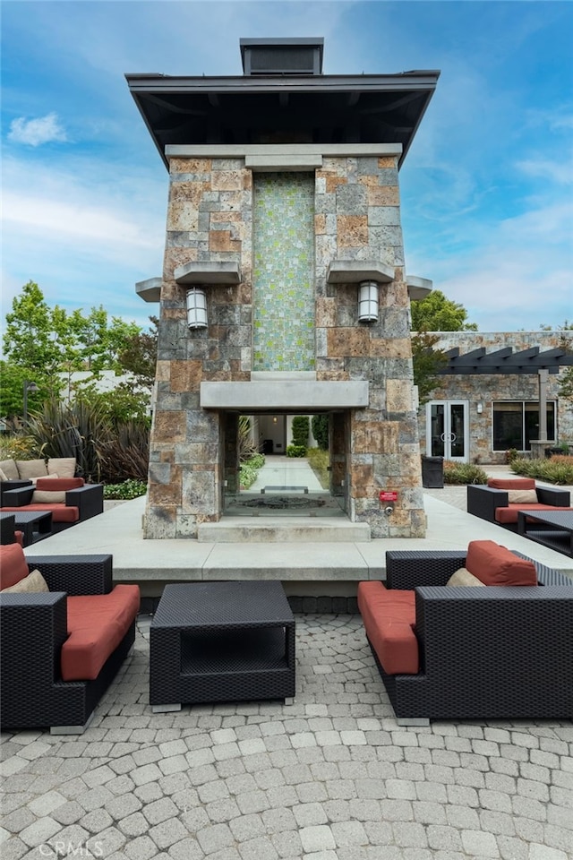 view of patio / terrace with an outdoor living space with a fireplace