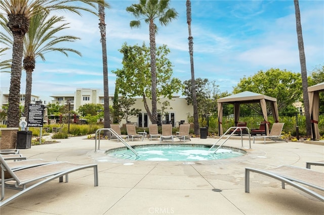 view of swimming pool featuring a gazebo, a hot tub, and a patio area