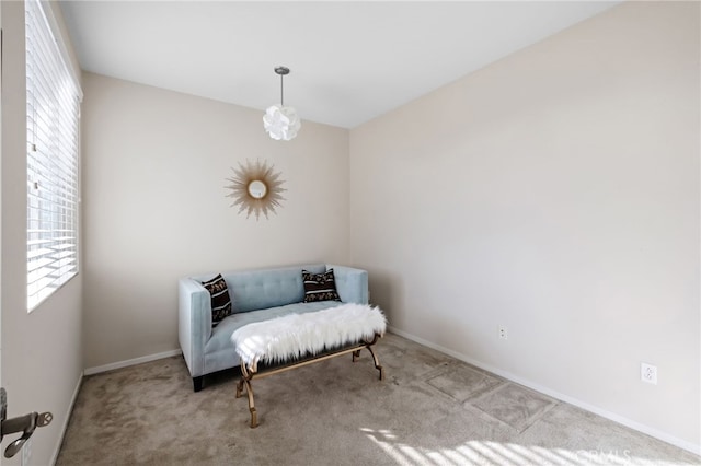 sitting room featuring light colored carpet