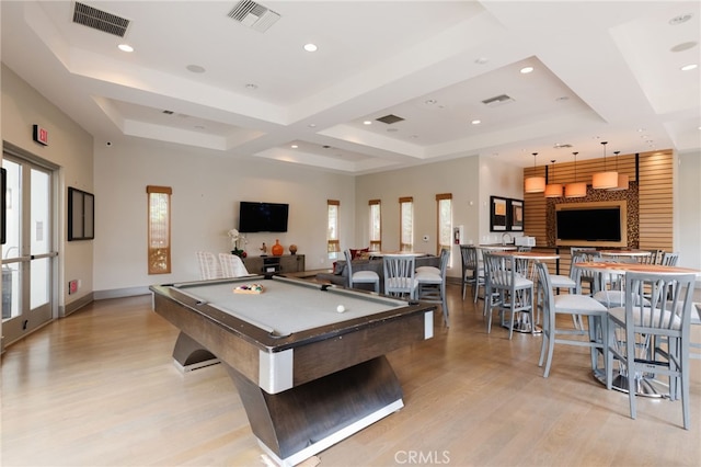 recreation room featuring pool table, light hardwood / wood-style flooring, and a raised ceiling