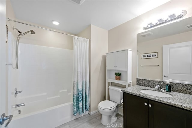 full bathroom with vanity, shower / tub combo with curtain, and toilet