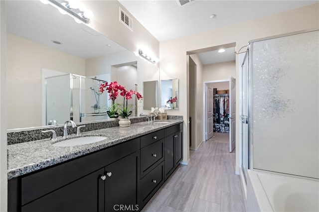 bathroom featuring vanity and a shower with shower door