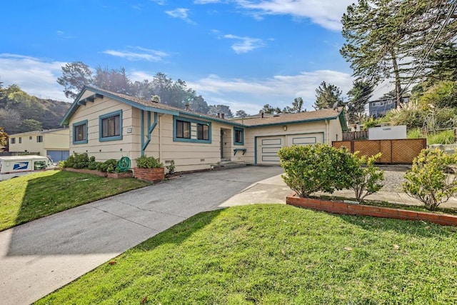 view of front of property with a garage and a front yard