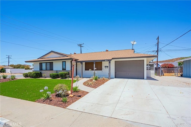 single story home featuring a garage and a front lawn