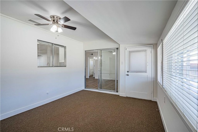 unfurnished bedroom featuring a closet, ceiling fan, and dark colored carpet