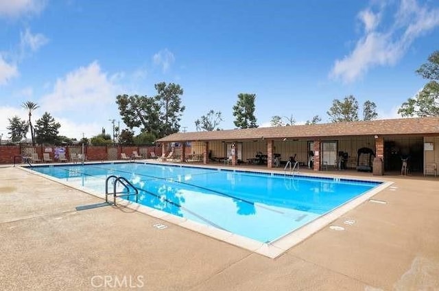 view of swimming pool featuring a patio area