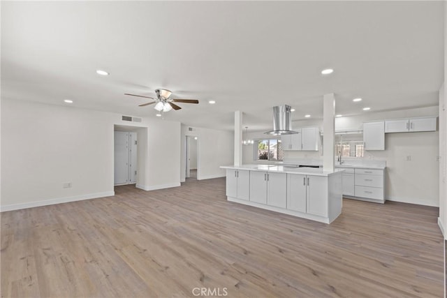 29460 Thornhill, Menifee, CA 92586 - kitchen featuring baseboards, open floor plan, a center island, light countertops, and light wood-style floors
