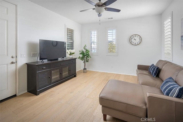 living room featuring ceiling fan and light wood-type flooring