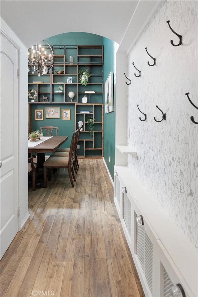 interior space featuring an inviting chandelier and wood-type flooring