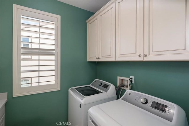 laundry room with cabinets and washer and dryer