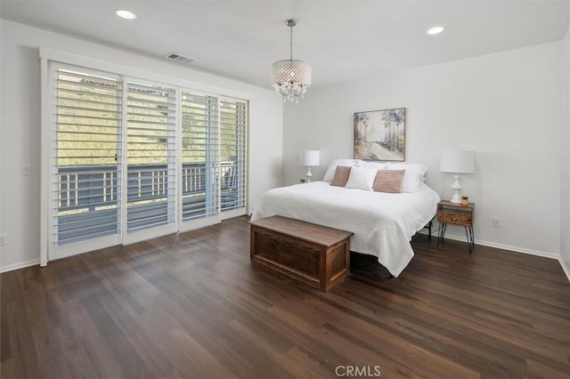 bedroom with access to exterior, dark hardwood / wood-style flooring, and a notable chandelier